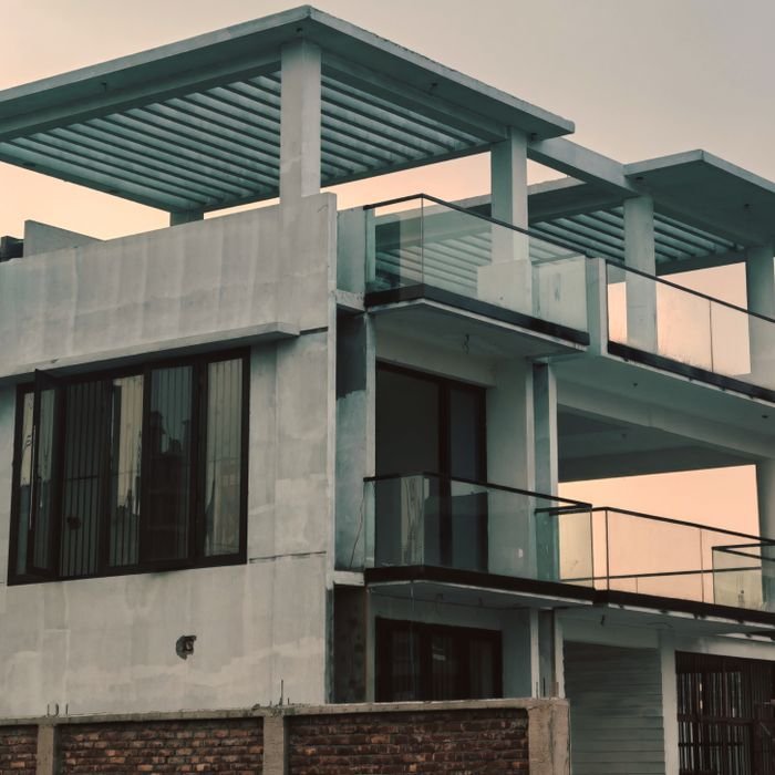 Contemporary multi-storey building with glass features in urban setting.