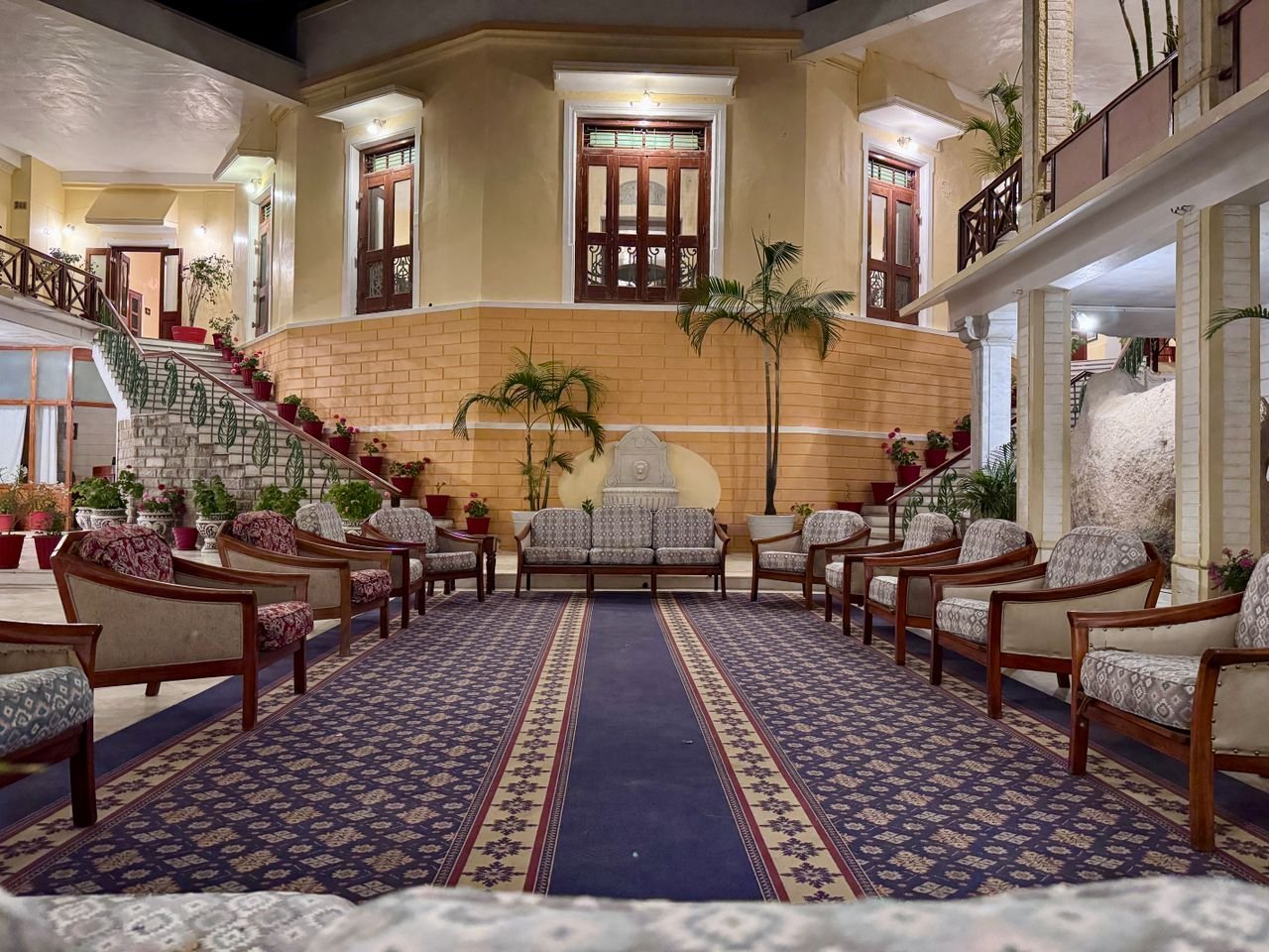 Beautifully arranged seating area in a villa lobby with elegant decor and intricate design.